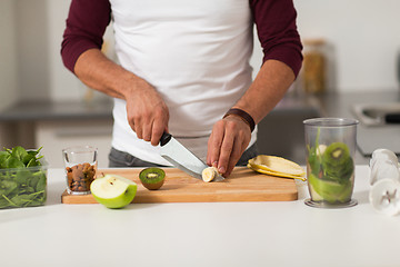 Image showing man with blender and fruit cooking at home kitchen