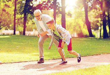 Image showing grandfather and grandson racing at summer park