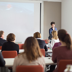 Image showing Woman giving presentation in lecture hall at university.