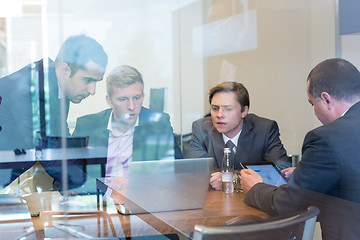 Image showing Business people sitting and brainstorming at corporate meeting.