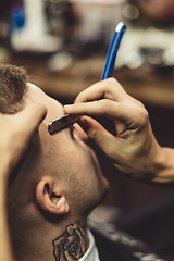 Image showing Crop stylist shaving client