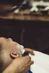 Image showing Anonymous man shaving client