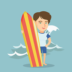 Image showing Young caucasian surfer holding a surfboard.