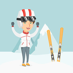 Image showing Young caucasian skier standing with raised hands.