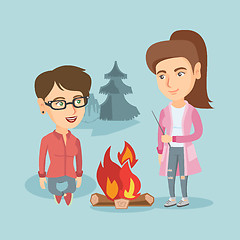 Image showing Two friends sitting around bonfire in the camping.