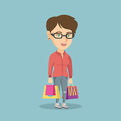 Image showing Young happy caucasian woman with shopping bags.