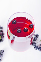 Image showing Glass of aronia juice with berries