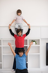 Image showing young boys posing line up piggyback