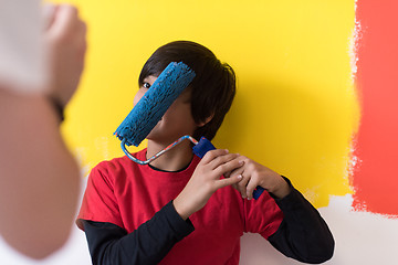 Image showing young boy painter with paint roller