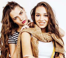 Image showing best friends teenage girls together having fun, posing emotional on white background, besties happy smiling, lifestyle people concept close up