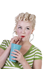 Image showing Woman in pin-up dress drinking - Isolated