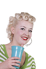 Image showing Woman in pin-up dress drinking - Isolated