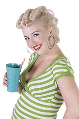 Image showing Woman in pin-up dress drinking - Isolated