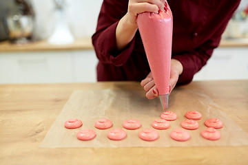 Image showing chef with injector squeezing macaron batter