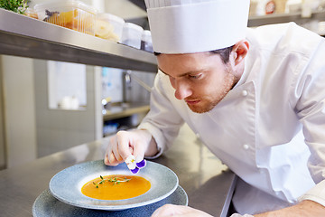 Image showing happy male chef cooking food at restaurant kitchen