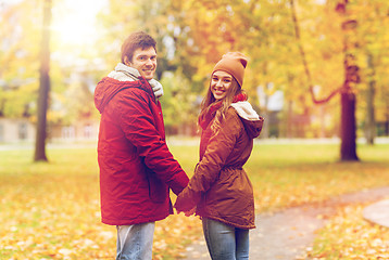 Image showing happy young couple walking in autumn park