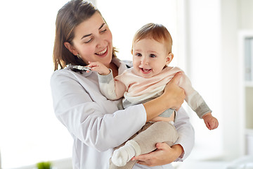Image showing doctor or pediatrician holding baby at clinic
