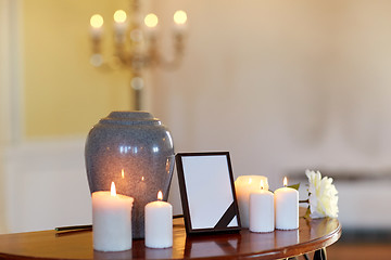 Image showing photo frame, cremation urn and candles in church