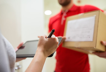 Image showing customer with tablet pc signing for parcel