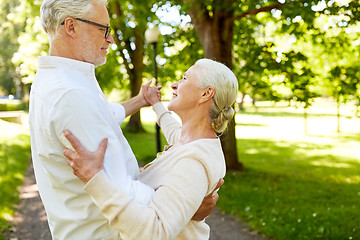 Image showing happy senior couple dancing at summer city park