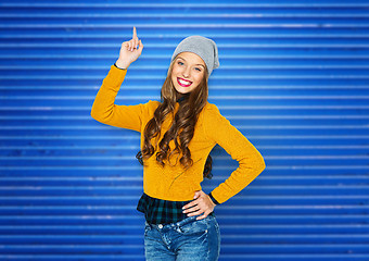 Image showing happy young woman or teen girl pointing finger up