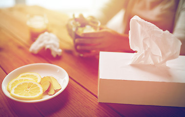 Image showing ill woman drinking tea with lemon and ginger