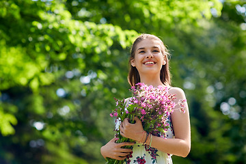 Image showing happy young woman with flowers in summer park