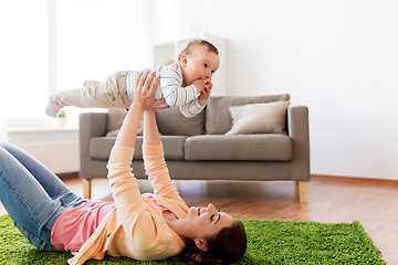 Image showing happy young mother playing with baby at home