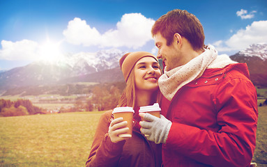 Image showing happy couple with coffee cups over alps mountains