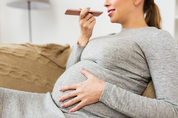 Image showing pregnant woman using voice recorder on smartphone