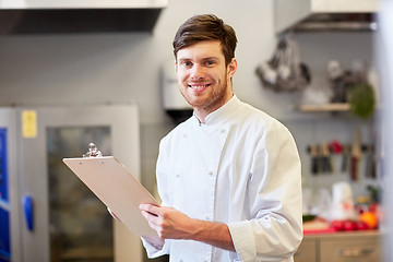 Image showing chef with clipboard doing inventory at restaurant