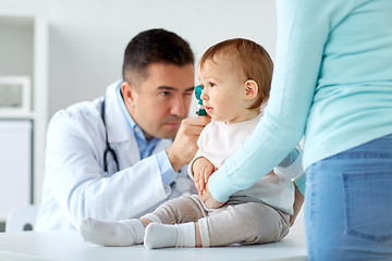 Image showing doctor checking baby ear with otoscope at clinic