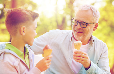 Image showing old man and boy eating ice cream at summer park