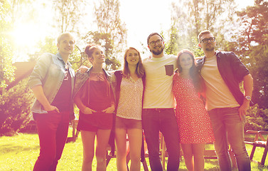 Image showing happy teenage friends hugging at summer garden