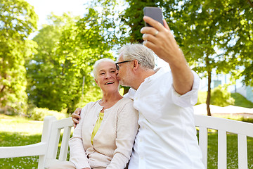 Image showing senior couple with smartphone taking selfie