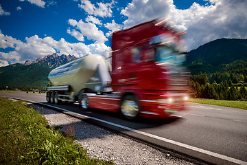 Image showing Fuel truck rushes down the highway in the background the Alps. T