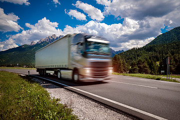 Image showing Fuel truck rushes down the highway in the background the Alps. T