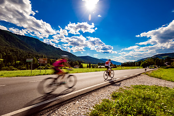 Image showing Cyclists riding a bicycle on the road in the background the Dolo