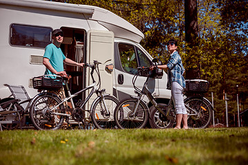 Image showing Woman with a man on electric bike resting at the campsite.