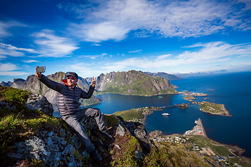 Image showing Man on top of a mountain taking a selfie