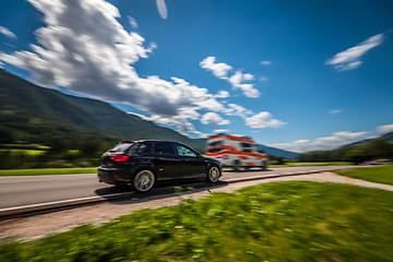 Image showing Car at high speed gives way to ambulance road