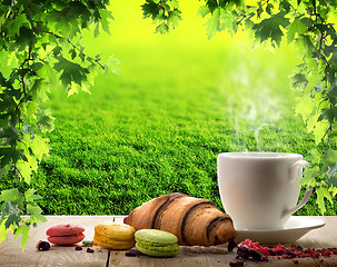 Image showing White cup and macaroons