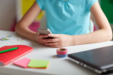 Image showing girl with smartphone messaging at home