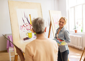 Image showing artist women with easels painting at art school