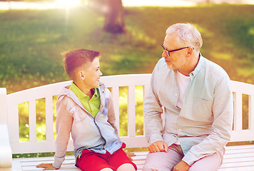 Image showing grandfather and grandson talking at summer park