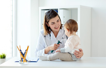 Image showing doctor with baby and otoscope at clinic