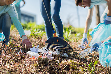 Image showing volunteers with garbage bags cleaning park area