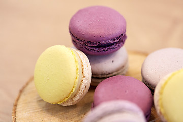 Image showing close up of different macarons on wooden stand