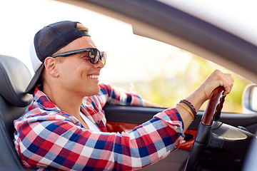 Image showing happy young man in shades driving convertible car