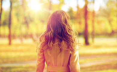 Image showing beautiful young woman walking in autumn park